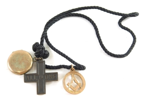 A 9ct gold Masonic fob, set with compass and set square, 3g, gold plated locket and a cross, attached to a cord chain.