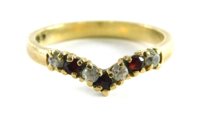 A 9ct gold wishbone ring, set with garnets and CZ, each in claw setting, ring size O½, 2.3g all in.