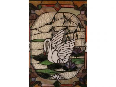 An early 20thC stained glass panel depicting a swan