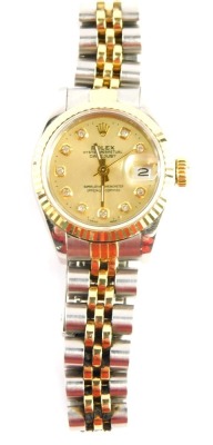 A Rolex Oyster Perpetual Datejust ladies wristwatch, the stainless steel strap with gold coloured dial with diamond set inserts and date aperture, lugs numbered 468B, boxed, with guarantee booklet, 53.1g all in.