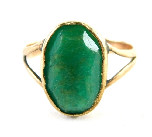 A 9ct gold polished jade dress ring, the oval jade in a rubover setting with V splayed shoulders, ring size K½, 1.9g all in.