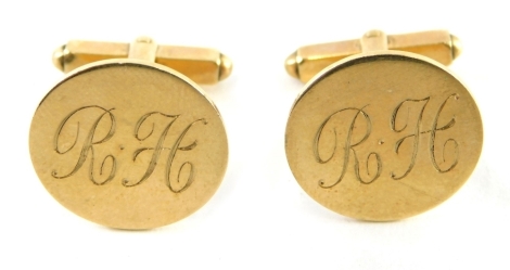 A pair of 9ct gold cuff links, each with a circular head bearing the initials RH, stamped 9ct, 8.9g.