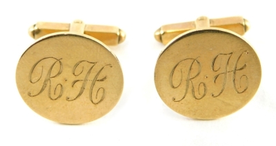 A pair of 9ct gold cuff links, each with a circular head bearing the initials RH, stamped 9ct, 8.9g.