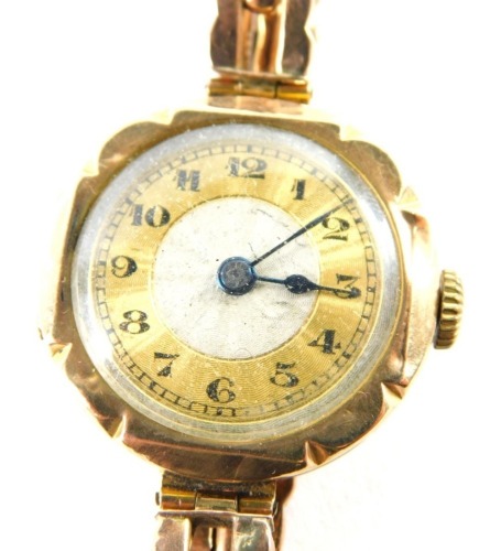 A 9ct gold ladies wristwatch, with a circular watch head with silvered and gold dial with blue hands, on an expanding bracelet, 16.7g all in.