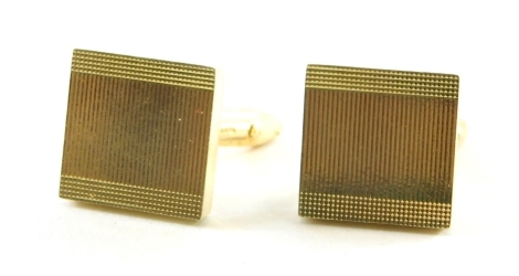 A pair of 9ct gold square set cuff links, each with engine turned decoration, 9.8g all in.