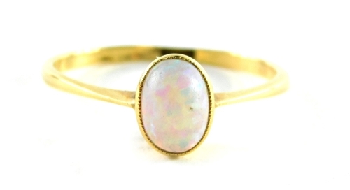 An opal dress ring, the oval opal in a raised basket on a yellow metal band stamped 18ct, ring size P, 1.8g all in.