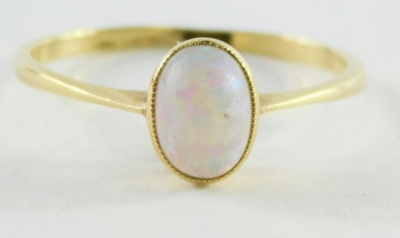 An opal dress ring, the oval opal in a raised basket on a yellow metal band stamped 18ct, ring size P, 1.8g all in. - 2