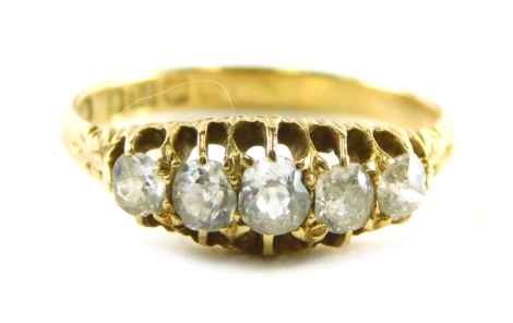 An 18ct gold diamond gypsy ring, set with five old cut diamonds, each in claw setting with scroll design shoulders, ring size O½, 2.9g all in.