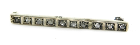 An Art Deco diamond rose cut brooch, the bar set with ten diamonds, white metal marked 18ct, diamonds totally approximately 0.05 carats overall, 4.4cm wide, 3.4g all in, boxed.