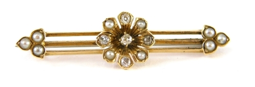 An Art Deco diamond and seed pearl bar brooch, a three bar design with central floral cluster and three leaf clover ends, yellow metal stamped 15ct, with replacement steel pin back, 4.5cm wide, 3.7g all in, boxed.