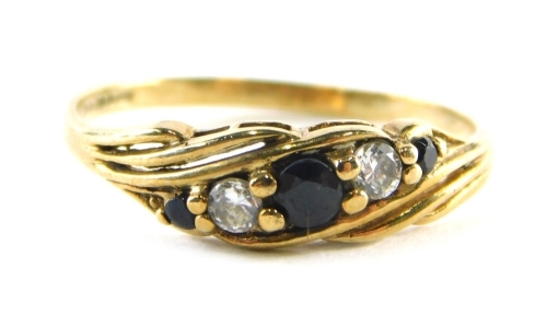 A 9ct gold sapphire and diamond dress ring, set with three sapphires and two diamonds, raised basket setting, ring size P½, 1.4g all in.