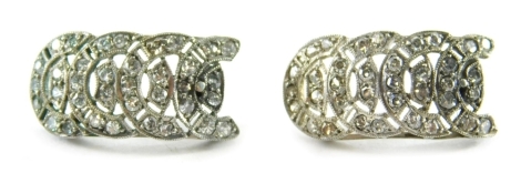 A pair of Art Deco diamond drop earrings, each of a curved drop with four row horseshoe type design, set with tiny diamonds in a white metal setting, tests as platinum, on stick pin back with butterfly backs, 2.5cm high, 4.3g, boxed.