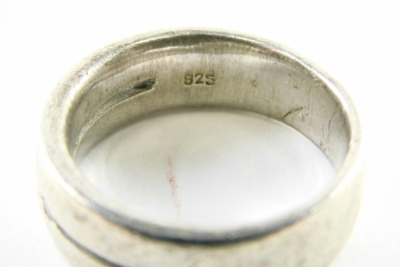 A sterling silver band, set with small white stones, size V, and another, in Buckingham Palace box. (2) - 2