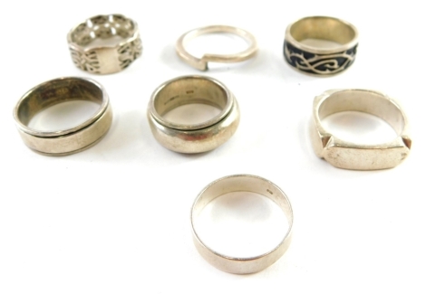 Seven silver and other dress rings, comprising woven design, enamel set wedding bands, etc., all stamped 925, 54.4g all in.