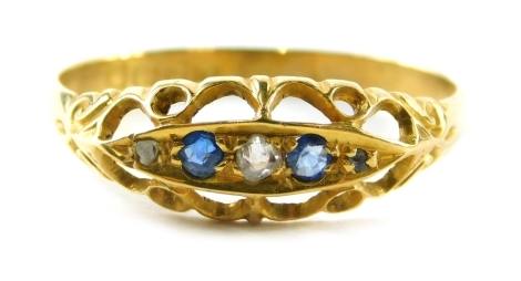 An 18ct gold sapphire and diamond gypsy ring, set with three round brilliant cut diamonds and two sapphires, on a scroll design set in ring size U½, 1.9g.