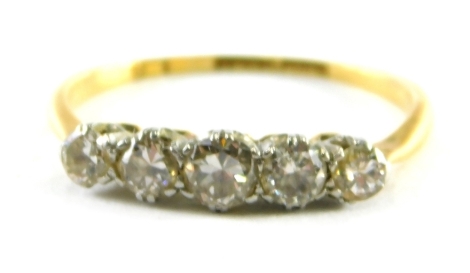 An 18ct gold five stone diamond dress ring, with five round brilliant cut stones, each in claw setting, on a thin yellow gold band, ring size K, 1.7g all in.