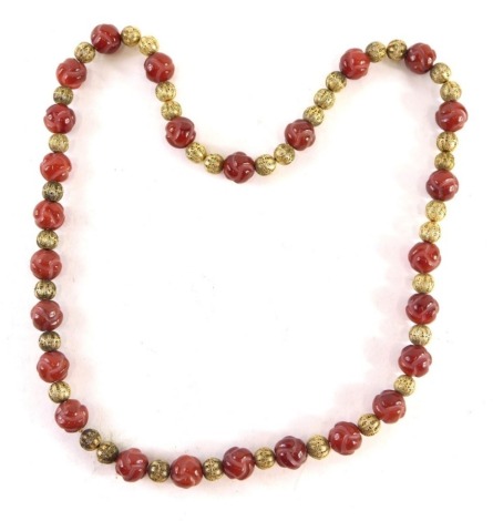 An Eastern beaded necklace, with faceted orange coloured beads, with filigree ball design, 70cm long.