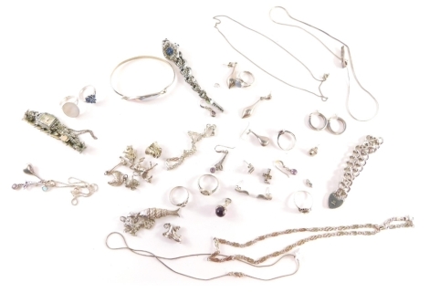 A group of silver and other costume jewellery, comprising two ladies bracelets, pendants, articulated fish, horse, dog, ball and claw pendant, bangle, neck chain, dress rings, gate bracelets, etc., 167g all in.