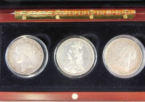 A Victorian three coin crown group, young head, jubilee head, veiled head. (3 coins, cased)