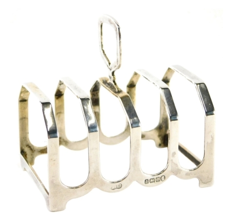 A George V silver toast rack, with shaped handle and four sections, Birmingham 1935, 8cm high, 1.3oz.