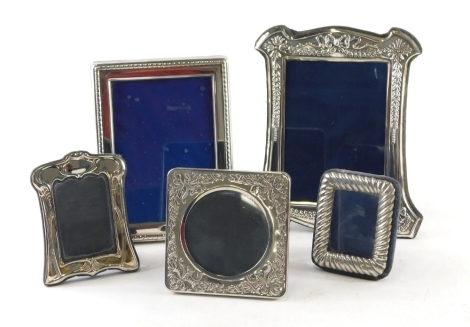 An Elizabeth II silver photograph frame, with oblong body and blue velvet easel back, Birmingham 1993, 9cm x 7cm, and four other photograph frames, silver plated. (a quantity)