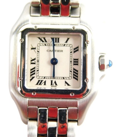 A Cartier lady's Santos wristwatch, early 2000s, with 1.5cm wide dial, stainless steel pierced bracelet, in outer case, with paperwork, cleaning kit, outer box and other ephemera.