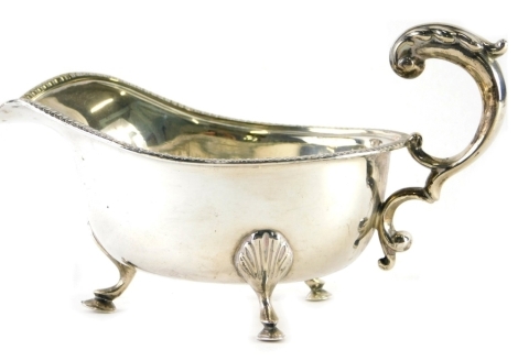 A George V silver sauce boat, Alex Clark and Co, with flying S scroll handle, on triple hoof feet, Birmingham 1924, 11cm high, 6.7oz.