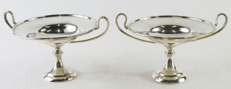 A pair of Edward VII silver miniature tazza, by Holland Aldwinckle & Slater, with strapwork handles on inverted stems and circular feet, London 1910, 10cm high, 7.6oz. (2)