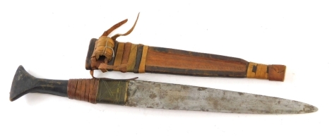 An Eastern dagger, with plain blade, leather scabbard and fishtail handle, partially turned with leather sections, 42cm long.