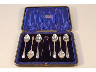 A set of six Edward VII silver teaspoons with matching sugar tongs