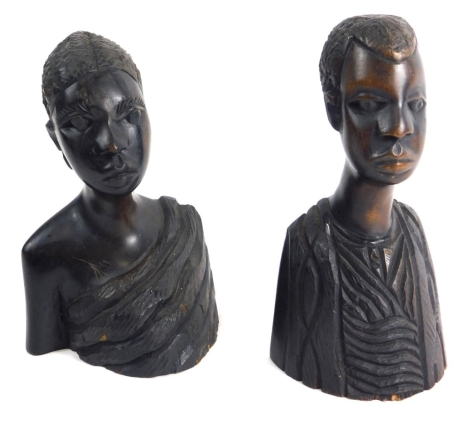 A pair of carved tribal figures of a lady and gentleman, each quarter profile, dressed in finery, 24cm high, etc. (2)