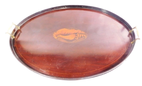 An Edwardian mahogany Sheraton revival galleried edge tea tray, centred with an oval shell patera with brass handles, 69cm wide.