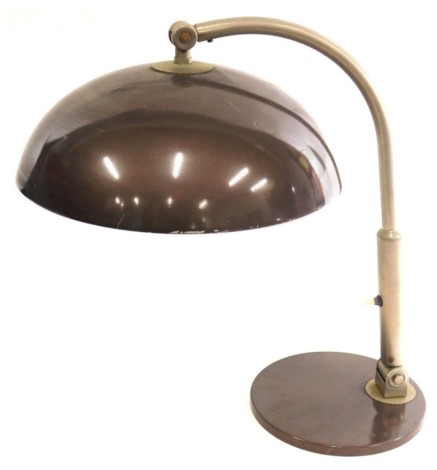 A vintage metal framed table lamp, with domed shade, in fawn, with articulated switch to the stem, on circular foot, unmarked, 35cm high.