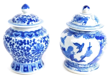 Two Chinese porcelain blue and white vases, probably mid 20thC, one decorated with flowers, the other decorated with panels of birds and flowers, marked beneath, 14cm high. (2)