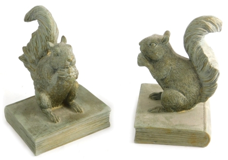 A pair of resin squirrel bookends, each figure stood on a book, unmarked, 22cm high.