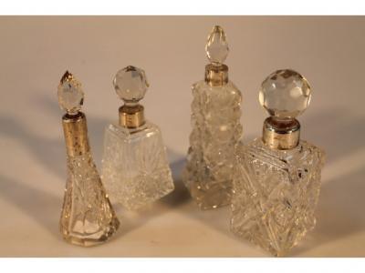 A group of four early 20thC cut glass scent bottles