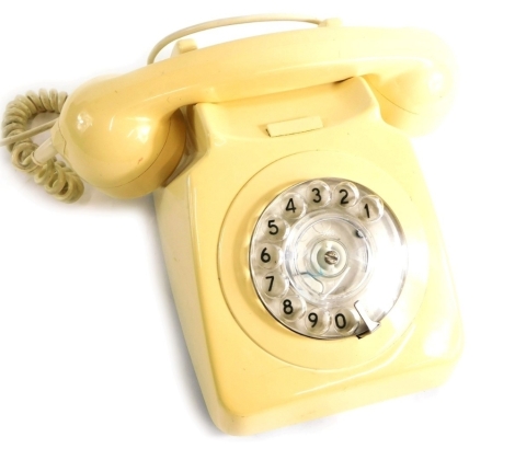 A vintage telephone in ivory colour, numbered 537394, with partial electric feature, 21cm wide receiver.