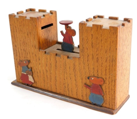 An oak articulated money box set with mouse to the centre weight activated for the coin, 16cm high