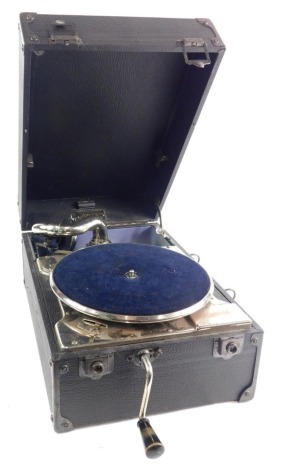 A mid 20thC Decca record player, with blue velvet lined turntable, front handle, chrome plated arm and chrome mounts, in pressed leather case, 30cm wide.