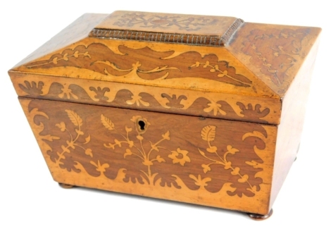 A 19thC rosewood and inlaid tea caddy, the sarcophagus lid revealing a sectional interior, the exterior profusely decorated with scrolls and fern leaves, on compressed bun feet, 17cm high, 22cm wide, 12cm deep.