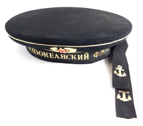 A Russian TNX00KEAHCKHH naval cap, with badge and interior diamond shaped label, with ribbon fastener, the interior 15cm x 20cm.