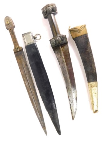 A curved edged Eastern dagger, with elaborate pommel and plain turned grip, and another with leather scabbard. (2)