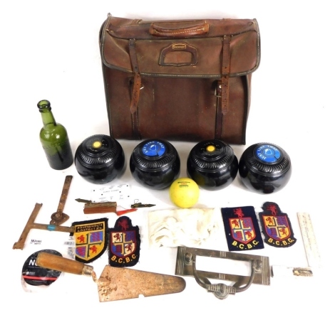 Various lawn boules in a Slazenger brown leather bag, 30cm high, a Hole and Comp green glass bottle etc. (a quantity)