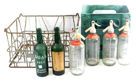 Various soda siphons Adcocks etc, 36cm high (5), in an 'on deposit' crate, and a metal wine rack