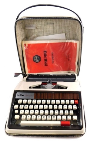 A vintage Brother Deluxe 3050 typewriter, with plastic wood effect fitting, articulated keys, in outer case, 33cm wide.