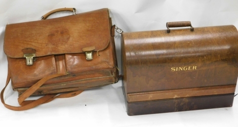 An early 20thC oak cased Singer sewing machine, and a leather satchel with fold over lid strap in tan, 41cm wide.