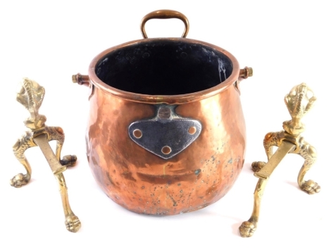 An early 20thC copper coal bucket, with swing and fixed handles 23cm high, and a pair of brass fire dogs.