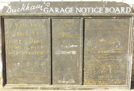 A vintage Duckham's Garage wooden notice board, in white white lettering.100cm x 145cm