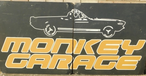 A garage advertising sign, with car, with yellow lettering in two parts, 110cm high each section approx 96cm wide.