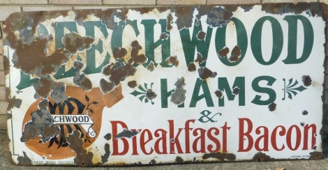 A Beechwood Hams and Breakfast Bacon advertising sign, in green red and black lettering on white ground. 68cm x 136cm